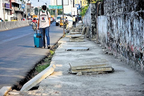 Pavements between Sholinganallur and Perumbakkam have not been laid for several months, leaving pedestrians to use the road | Ashwin Prasath