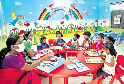Teachers and students interact at Presidency Government Primary School in Egmore, Chennai, after kindergarten classes resumed in Tamil Nadu on Wednesday. (Photo | Ashwin Prasath, EPS)