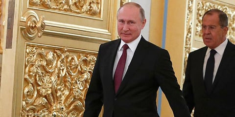 Russia President Vladimir Putin (L) and Foreign Minister Sergei Lavrov