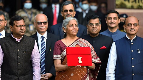 Finance Minister Nirmala Sitaraman shows the digital tablet wrapped in a traditional 'Bahi Khata' ahead of the 2022 Budget session.
