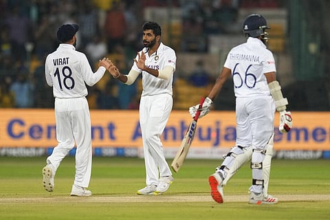 India's Jasprit Bumrah, center, celebrates with teammate Virat Kohli, left, after the dismissal of Sri Lanka's Lahiru Thirimanne, right, during the second day of the second Test match. (Photo | AP)