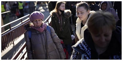 People wait in a line to board a train leaving for Lviv in Ukraine at the train station in Przemysl, Poland, Monday, March 14, 2022. (Photo | AP)