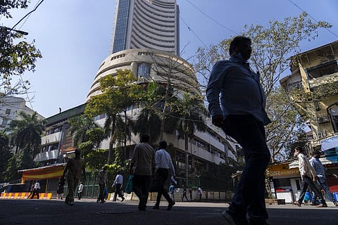 People walk past the Bombay Stock Exchange (BSE) building in Mumbai (Photo | AP)