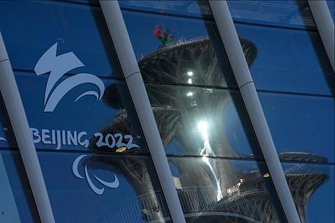 The Beijing Olympic Tower is reflected on the window panels of the Main Media Center displaying the logo of the 2022 Winter Paralympics in Beijing, China. ( Photo | AP)