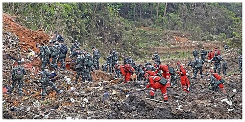 Rescue workers search for the black boxes at a plane crash site in Tengxian county, southwestern China's Guangxi Zhuang Autonomous Region, Tuesday, March 22, 2022. (Photo |AP)