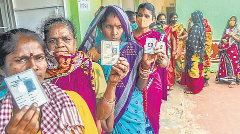 Women wait outside a booth to cast vote at Text Book Press Colony High School in Bhubaneswar on Thursday | Express