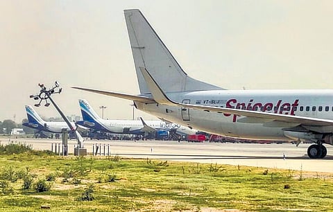 A SpiceJet aircraft after it hit a pole on the tarmac at IGI Airport on Monday. The damaged part of the plan is circled in the picture below | Pti