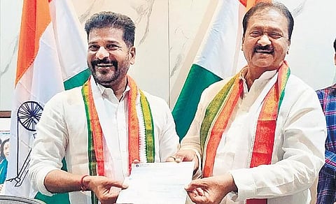 Congress leader Md Shabbir Ali hands over a cheque of `10 lakh for insurance premium of party activists to A Revanth Reddy on Thursday