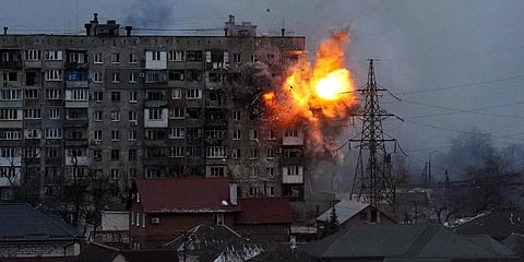 An explosion is seen in an apartment building after Russian's army tank fires in Mariupol, Ukraine.