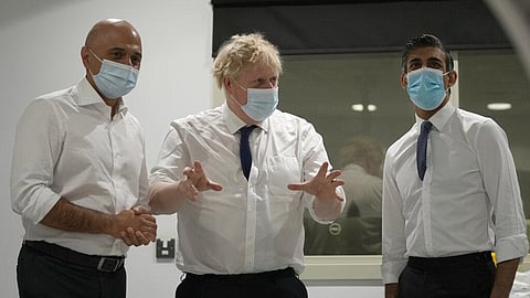 Britain's Prime Minister Boris Johnson, centre, Rishi Sunak, Chancellor of the Exchequer, right, and Sajid Javid, Secretary of State for Health and Social Care speak together. (Photo | AP)
