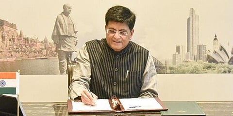 Union Minister Piyush Goyal signs the trade pact with Australia. (Photo| Twitter)