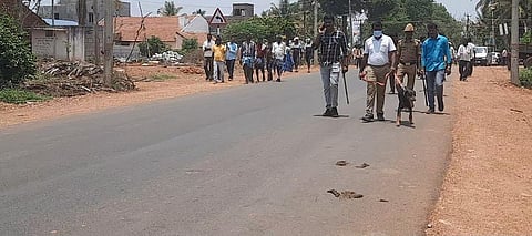 Police with the help of a sniffer dog conducting investigation at the village on Friday, April 22, 2022.