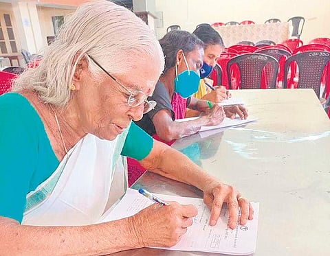 83-year-old P Malathi taking the literacy test conducted by the Kerala State Literacy Mission.