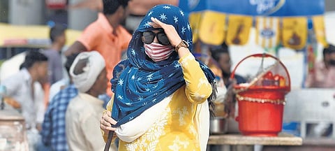 A women covers her head with a dupatta as she steps out in sizzling heat. (File Photo | Parveen Negi)