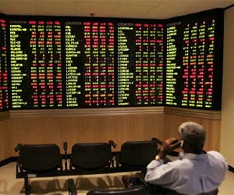 An investor monitors share market prices . ( Photo | Reuters)