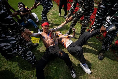 Indian policemen detain Tibetans during a protest outside the Chinese Embassy in New Delhi ( Photo | AP)