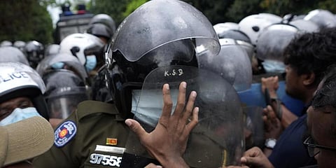 Students scuffle with police during a protest demanding president Gotabaya Rajapaksa's resignation near parliament in Colombo, Sri Lanka, Friday, April 8, 2022.(Photo | AP)