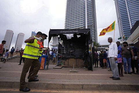 Police officers conduct investigations into aftermath of clashes between government supporters and anti government protesters in Colombo. (Photo | AP)