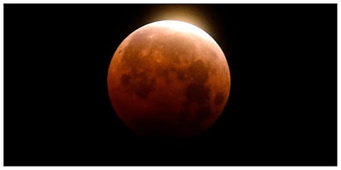 Light shines from a total lunar eclipse over Santa Monica Beach in Santa Monica, Calif., Wednesday, May 26, 2021.