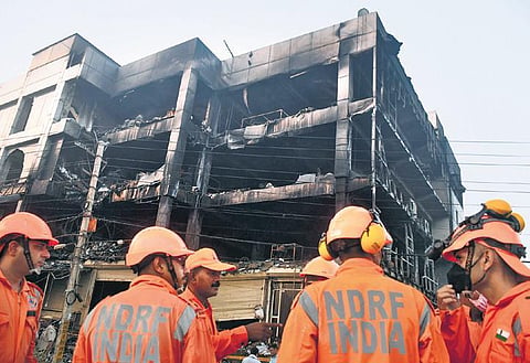 NDRF personnel during rescue work at the gutted building near Mundka Metro Station. (Photo | PTI)