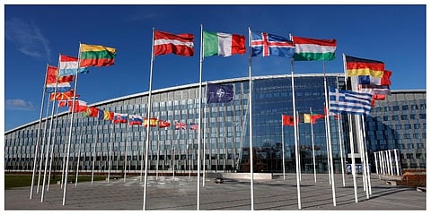 Flags flutter in the wind outside NATO headquarters in Brussels, February 7, 2022. (Photo |AP)