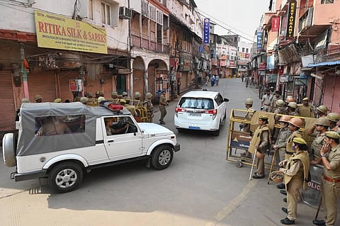 Security personnel stand guard as officials move towards Gyanvapi Masjid complex. (Photo | PTI)
