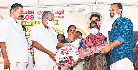 Former Chief Minister Pinarayi Vijayan hands over the key of a house completed under Life Mission to Ameerudeen-Aisha Beevi couple from Vettuthura in Thiruvananthapuram