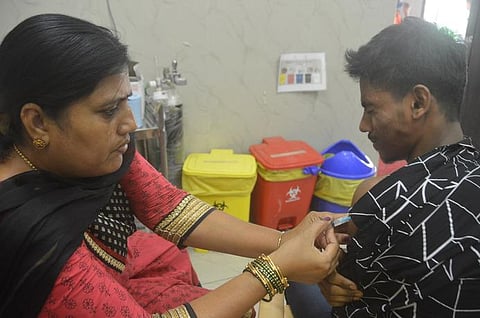 A health worker administers a booster dose of COVID-19 vaccine to a beneficiary in Bengaluru on Friday. (Photo | EPS)