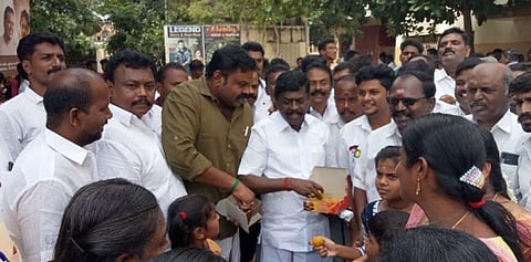 MLA E Raja and DMK district secretary Sivapadmanathan distributing sweets to people who came to watch Udhayanidhi Stalin starrer 'Nenjuku Needhi' movie