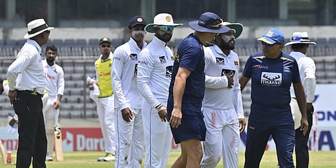 Sri Lanka's Kusal Mendis (3R) walks back to the pavilion amid chest pain during Day 1 of the 2nd Test match against Bangladesh at the Sher-e-Bangla National Cricket Stadium in Dhaka. (File photo| AFP)