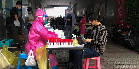 Residents line up to get a COVID-19 test in Shanghai. (Photo| AP)