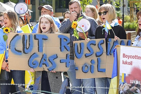 Ukrainian demonstrators demand an embargo on Russian oil during a protest in front of EU institutions prior to an extraordinary meeting of EU leaders to discuss Ukraine. (Photo | AP)