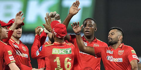 Kagiso Rabada of Punjab Kings celebrates with teammates, after taking the wicket of Wriddhiman Saha of Gujarat Titans during the IPL match at the DY Patil Stadium in Mumbai. (Photo | PTI)