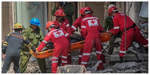 Rescuers recover a body at the site of Friday's deadly explosion that destroyed the five-star Hotel Saratoga, in Havana, Cuba, Saturday, May 7, 2022. (Photo | AP)
