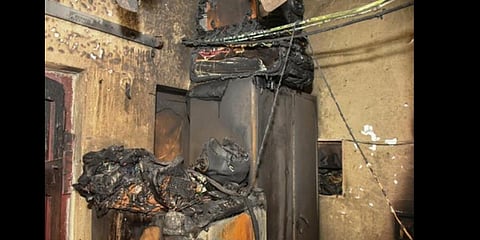 A house which was gutted after the battery of Boom Corbett 14 electric scooter (inset) exploded at Gulabi Thota in Vijayawada.(Photo| Prasant Madugula)