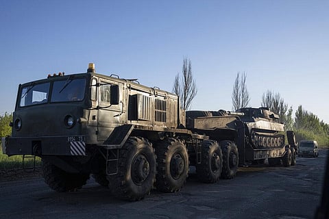 A military truck transports a platform with Ukrainian self-propelled artillery mount in Donetsk region, Ukraine, Sunday, May 8, 2022. (Photo | AP)