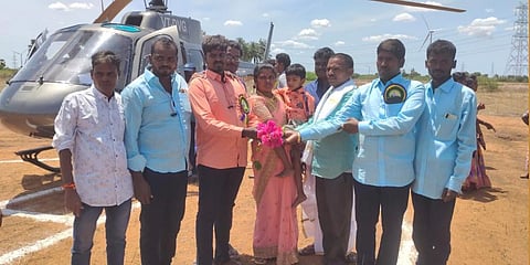 Natarajan and his family land in a helicopter to attend the temple festival in his native village on monday