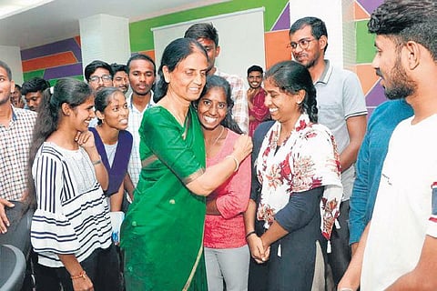 Education Minister P Sabitha Indra Reddy hugs a student during her visit to IIIT-Basara after the strike was called off, on Tuesday