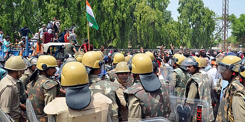 Police personnel stand guard at a demonstration against the Agnipath Recruitment Scheme for the Armed Forces, at the Agra-Delhi national highway, in Mathura. (File Photo| PTI)