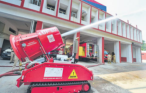 A robot demonstrates firefighting at Lakshmi Nagar Fire Station on Monday (Photo | PTI)