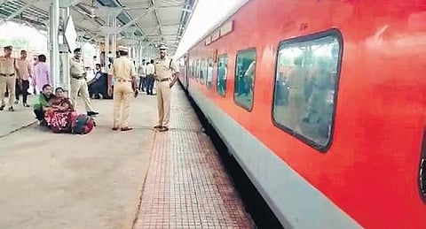 Police officials manage the crowd at the Dornakal Railway Station on Monday