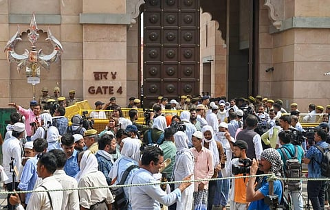 Security personnel stand guard as Muslims arrive in a large number at the Gyanvapi mosque to offer Friday prayers, in Varanasi, Friday, May 20, 2022. (Photo | PTI)