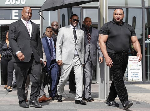 Singer R. Kelly leaves the Leighton Criminal Court Building after a hearing on sexual abuse charges in Chicago. (File Photo | AFP)