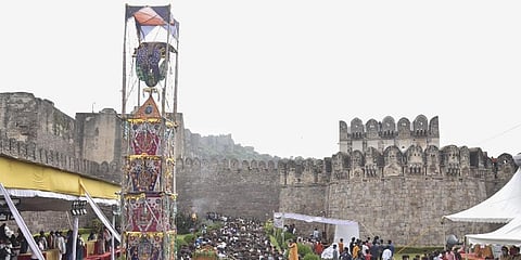 Devotees, flouting COVID-19 appropriate behaviour, participate in a procession near the Golconda Fort during the Ashada Bonalu festival, in Hyderabad. (File Photo | PTI)