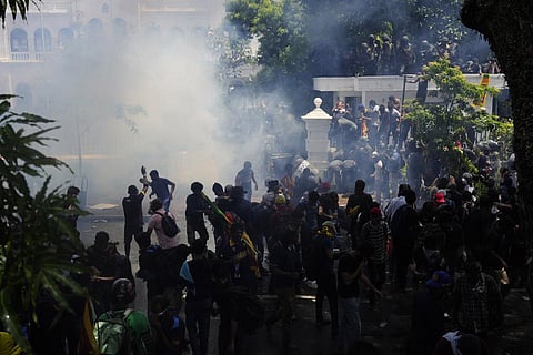 Sri Lanka declared a state of emergency Wednesday as thousands of people mobbed the prime minister's office after the country's president flew to Maldives, following months of protests against an econ