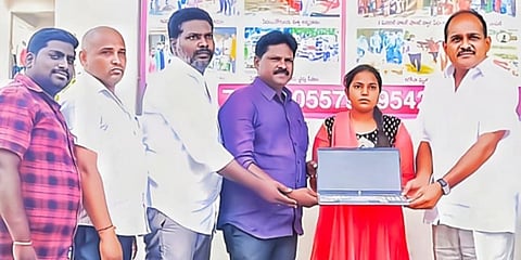 Gollapudi Srihari donating a laptop to a student. (Photo | Express)