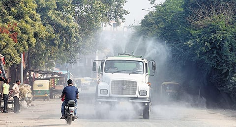 An anti-smog tanker sprays water into the air to reduce dust pollution in New Delhi. (Photo | Parveen Negi)