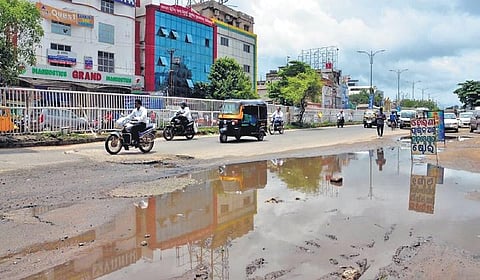 Commuters negotiate waterlogged and pothole-ridden Badambadi-Link Road stretch in Cuttack. (Photo| EPS)