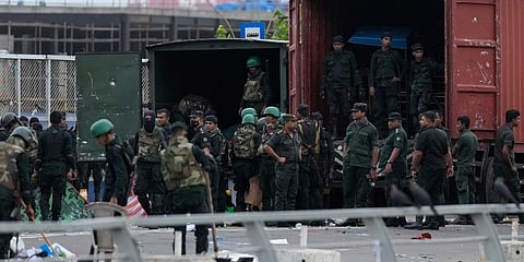 Army soldiers clear anti-government protest camps after an eviction of protesters from the presidential secretariat premise in Colombo. (Photo | AP)