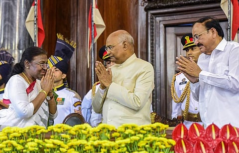 Newly sworn-in President Droupadi Murmu exchanges greetings with outgoing President Ram Nath Kovind and Vice President M Venkaiah Naidu in the Central Hall of Parliament. (Photo | PTI)